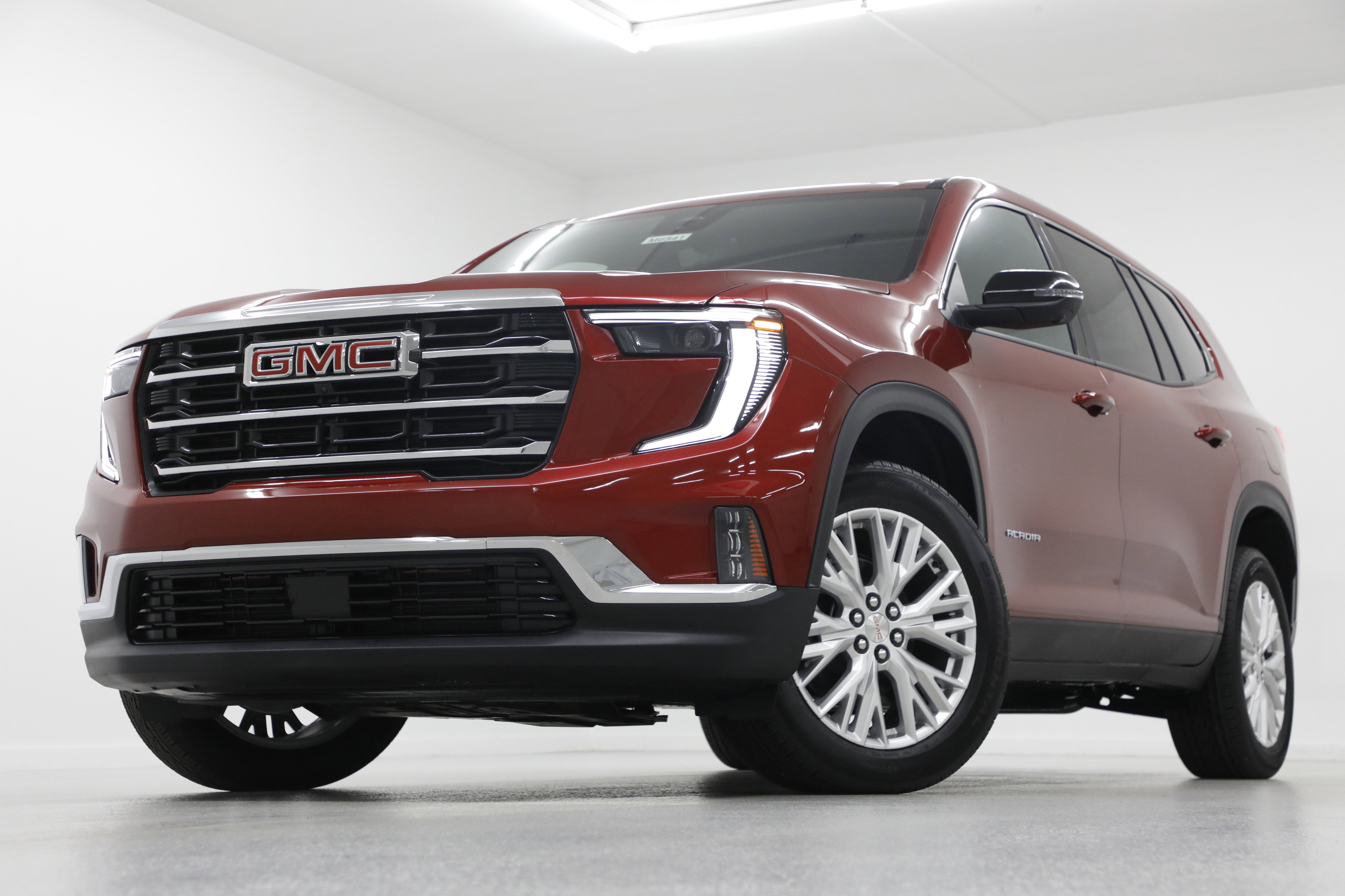 2026 GMC Acadia Elevation in Volcanic Red Tintcoat — front three-quarter view