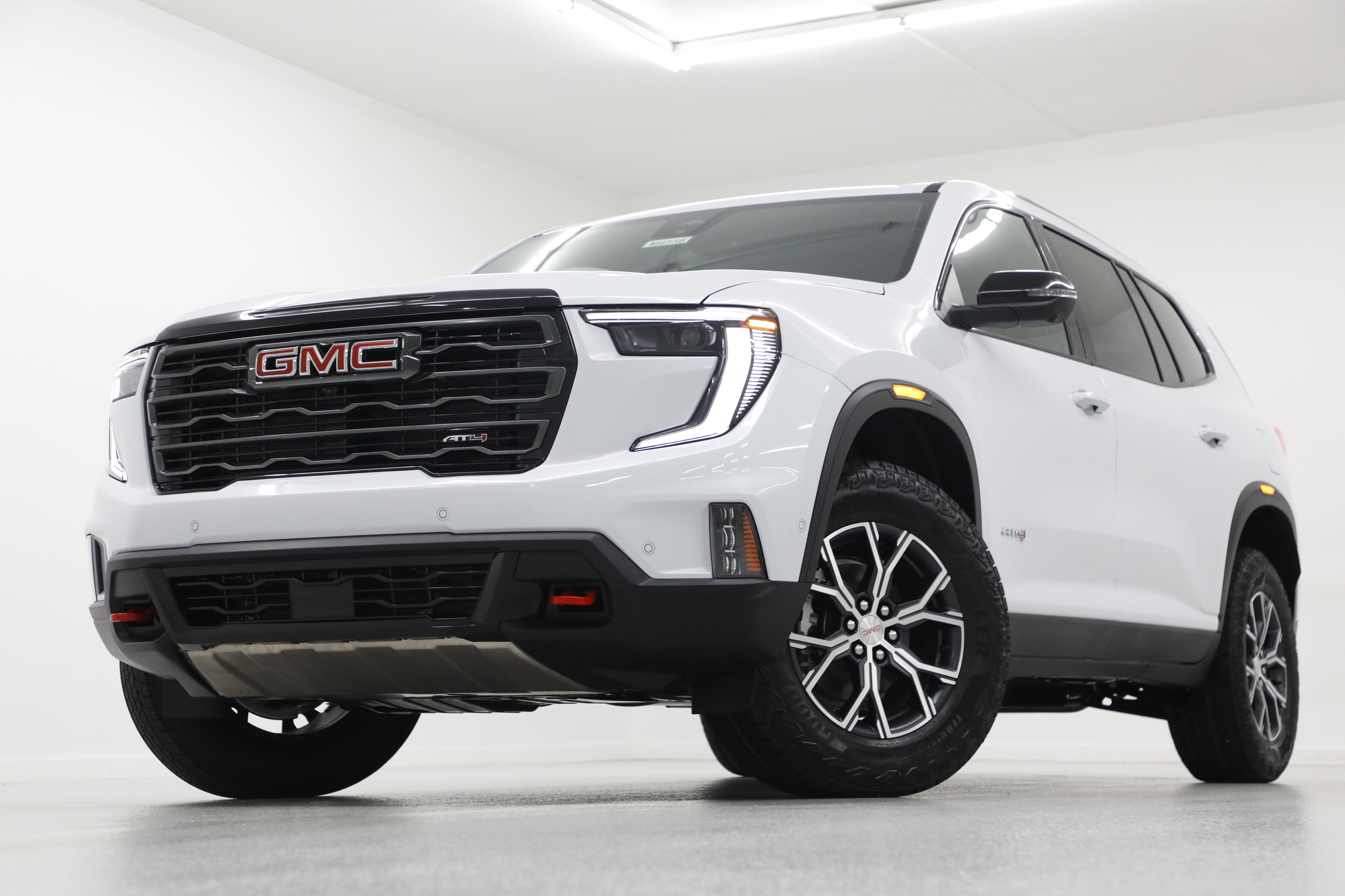 2026 GMC Acadia AT4 in Glacier White Tricoat — front three-quarter view