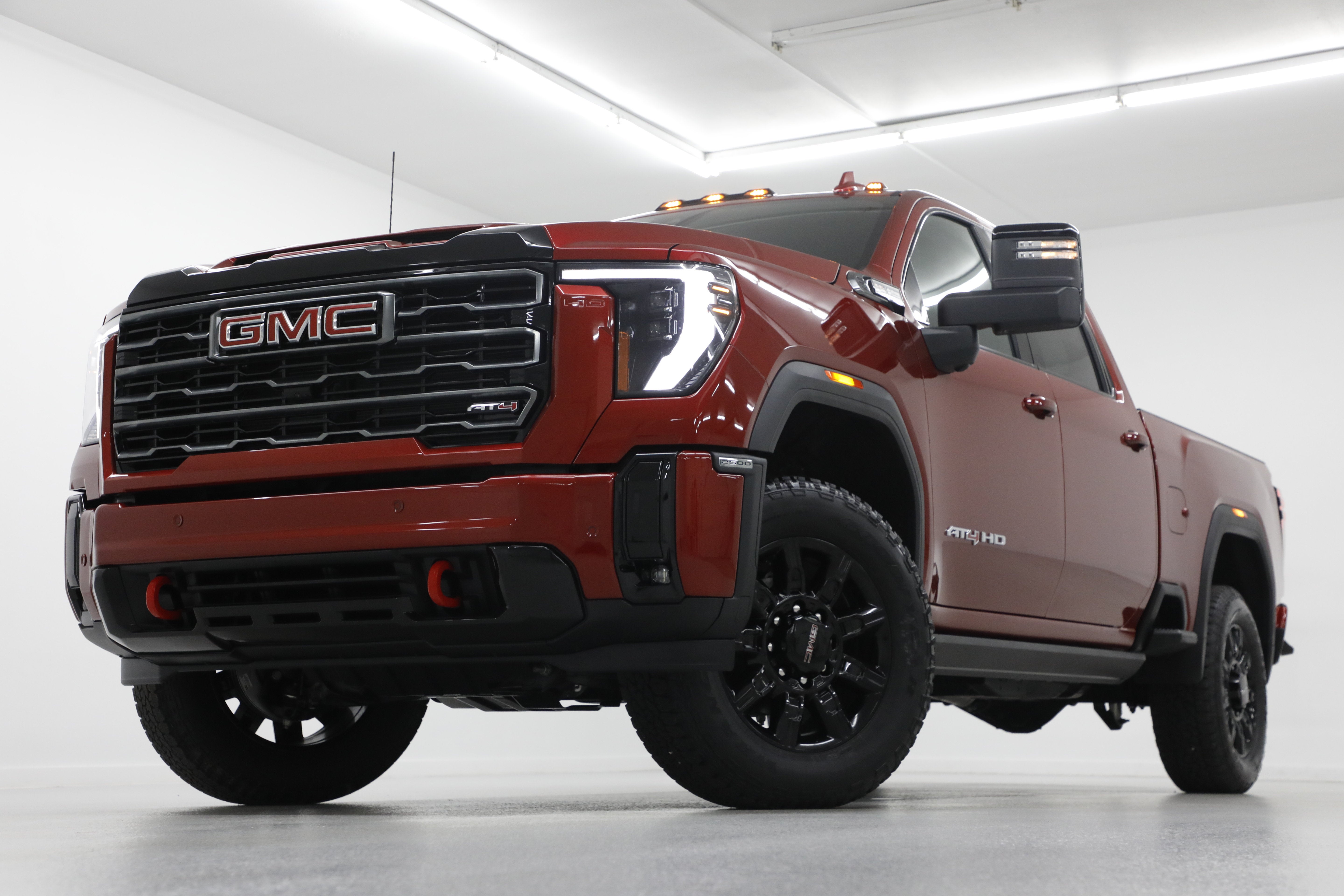2026 GMC Sierra 2500 HD AT4 in Volcanic Red Tintcoat — front three-quarter view